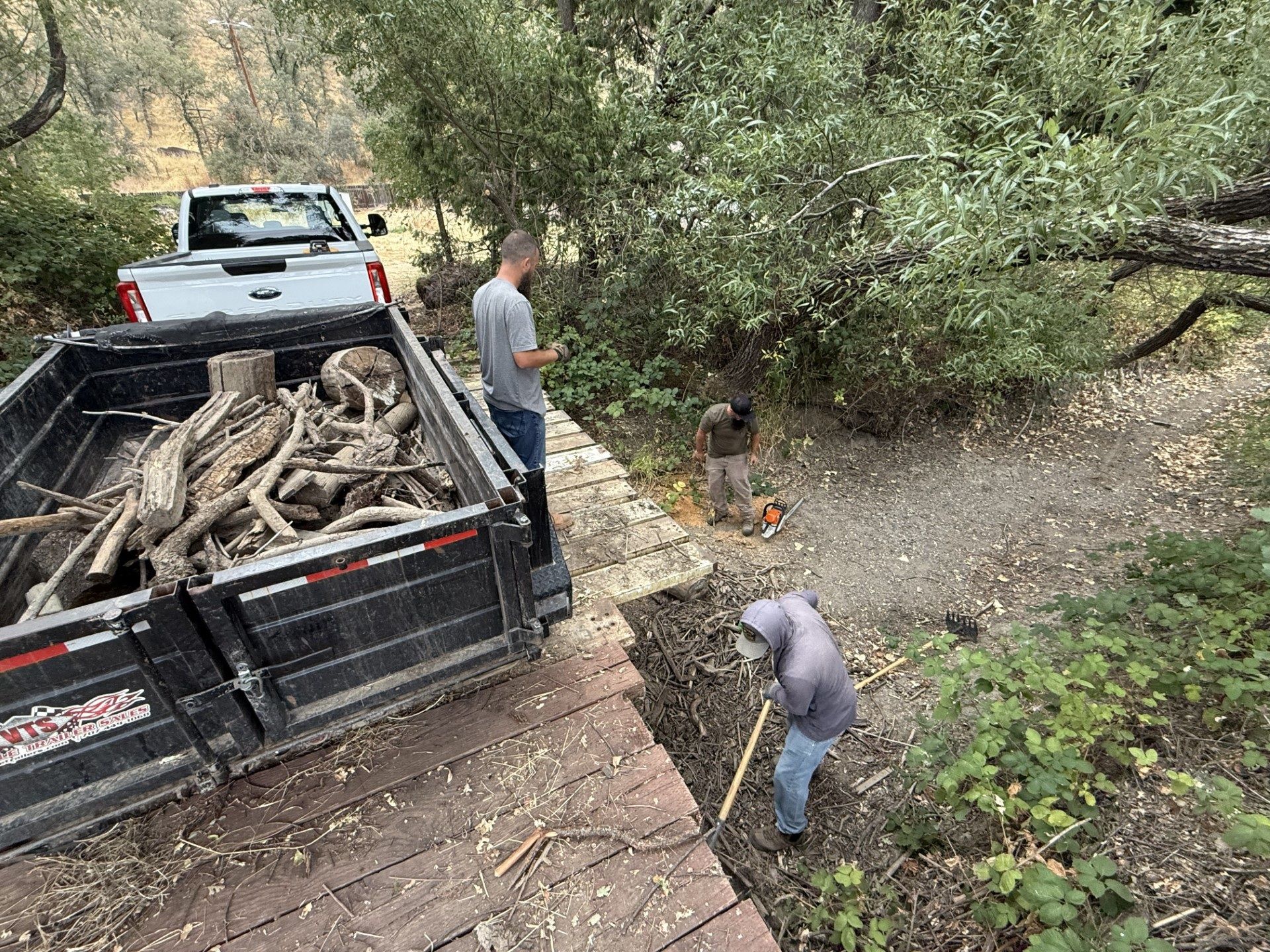 Lake County Water Resources crews load debris removed from beneath the bridge into a dump trailer