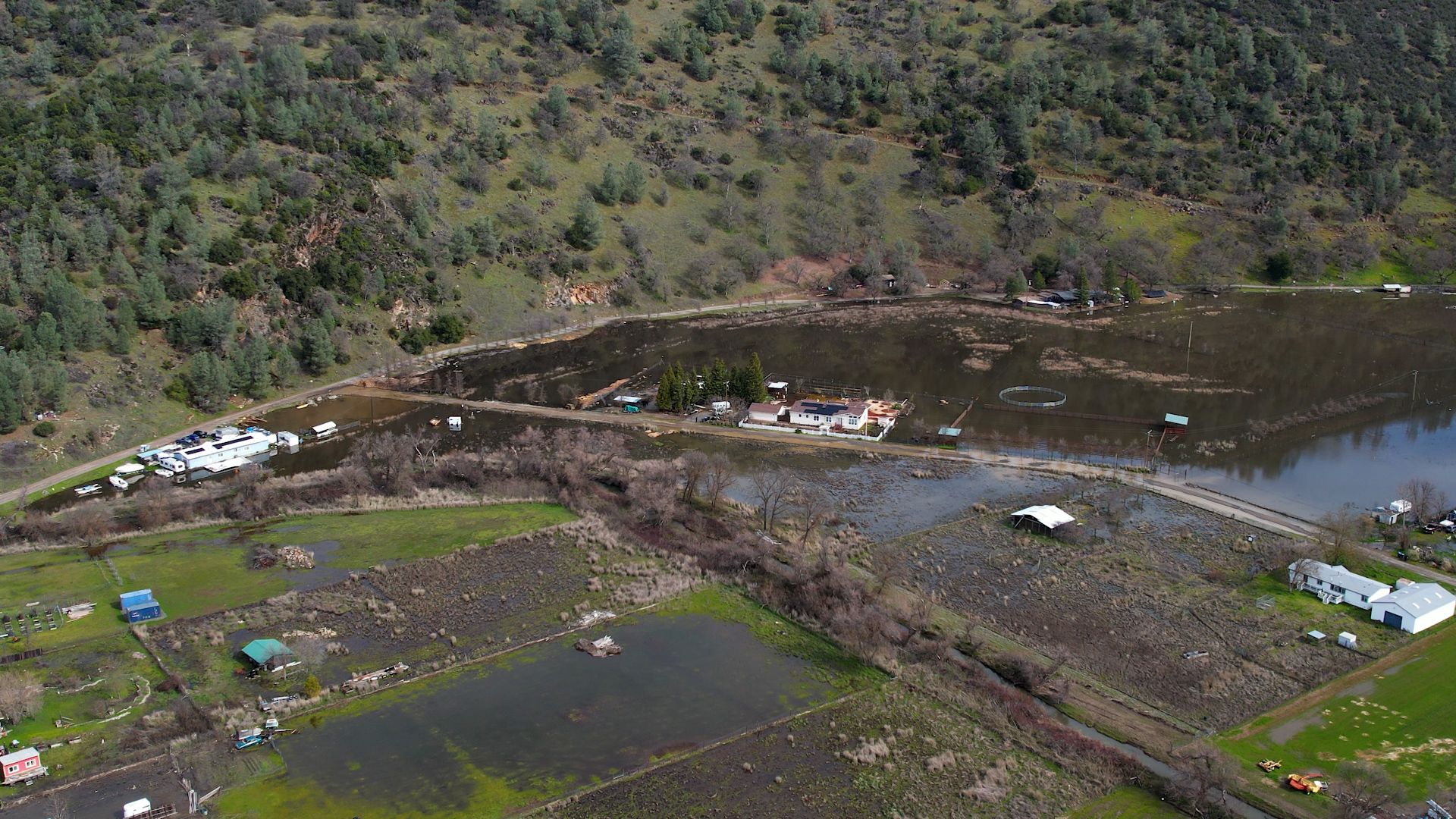 Downstream portion of Cole Creek levee (bend before Clark Dr. bridge) during flooded stage, February 2025. Source: Sam Euston, Euston Productions